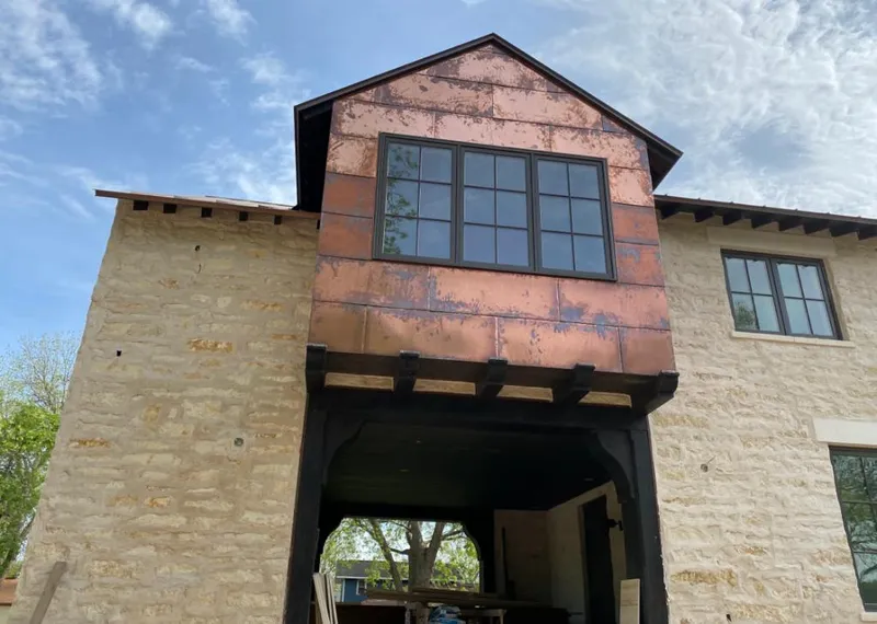 Copper metal panel facade on a stone building for Roof Repair in Jessup